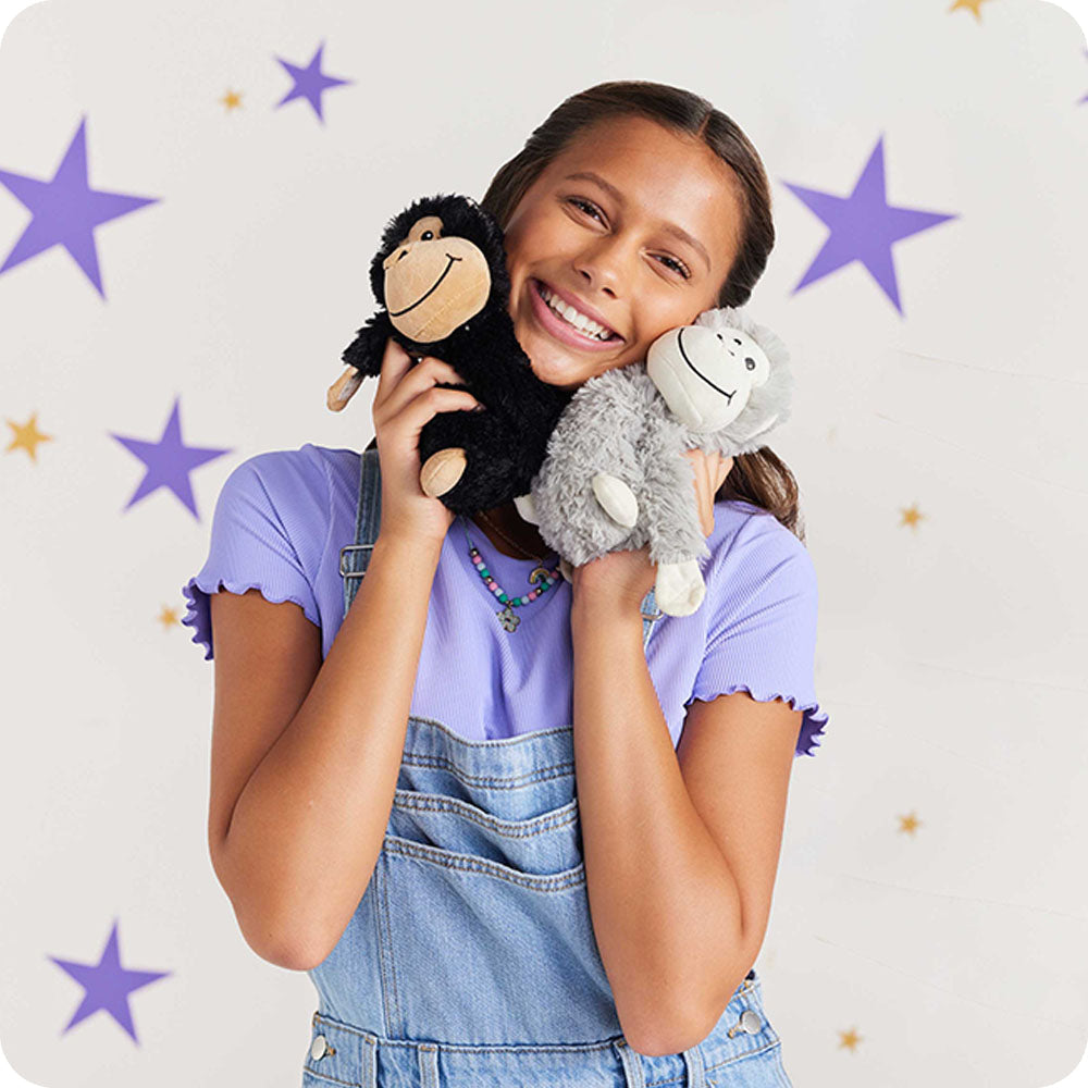Image 101: girl cuddling monkey hugs stuffed animals