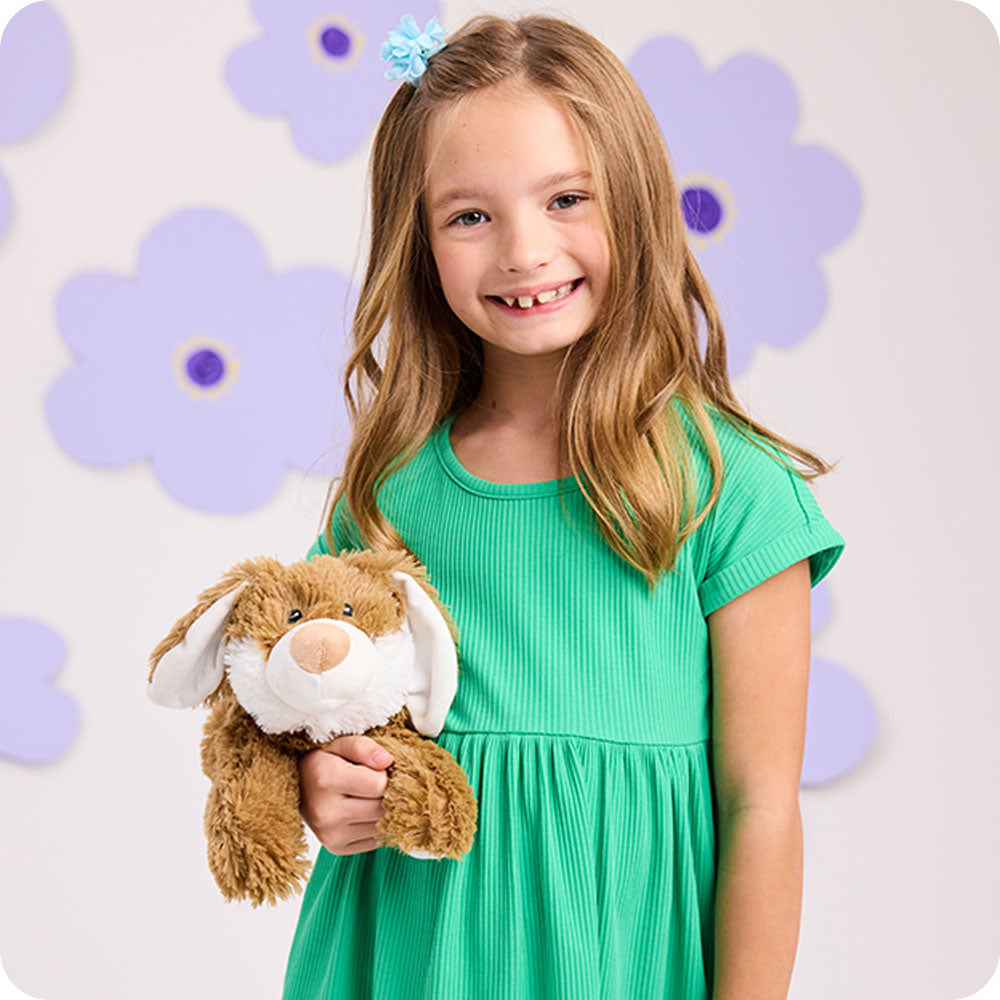 Image 103: girl holding brown bunny warmies flower lifestyle