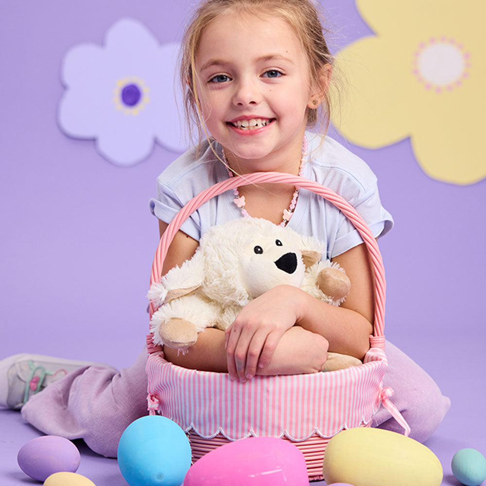 Image 97: girl holding sheep stuffed animal in easter basket