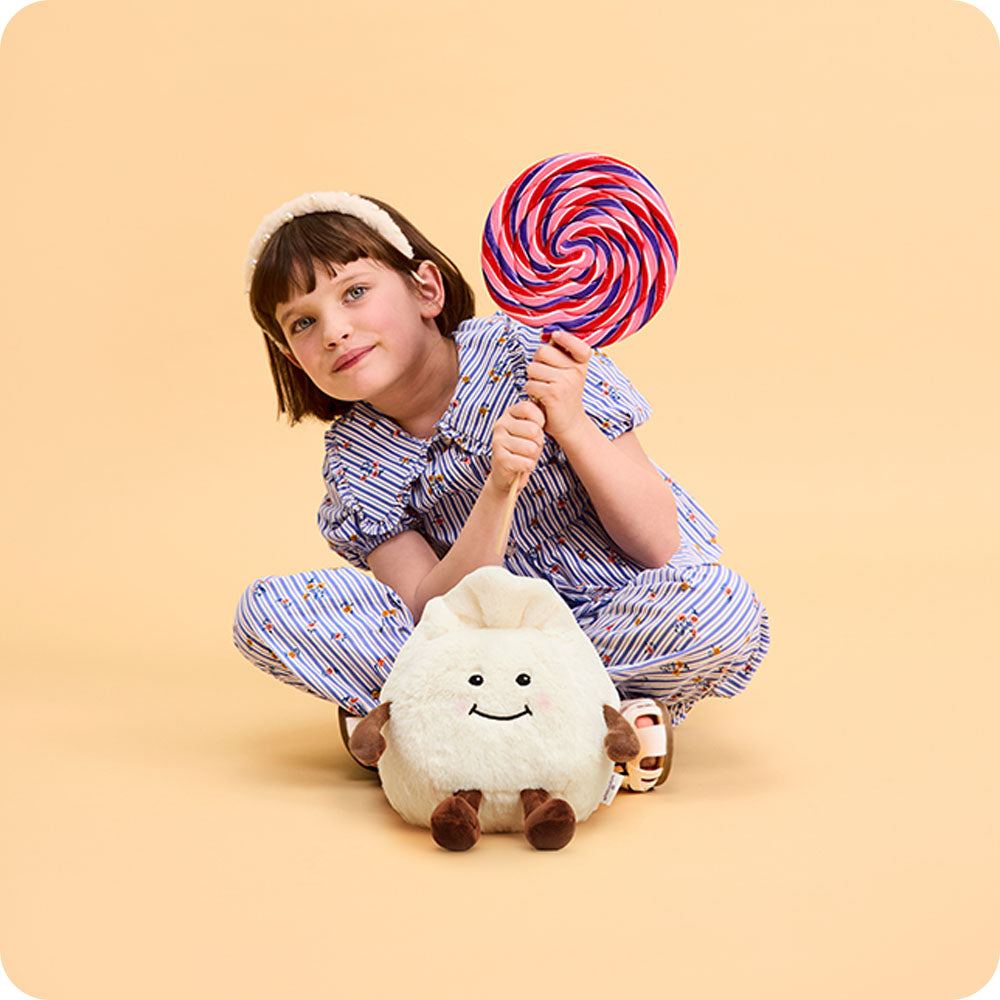 Image 99: girl with dumpling stuffed animal at her feet
