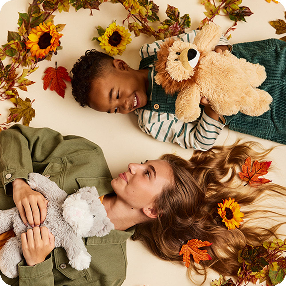 Image 102: kids holding cat and lion warmies stuffed animals