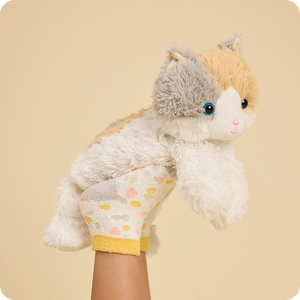 Image 113: calico cat stuffed animal resting on kids feet