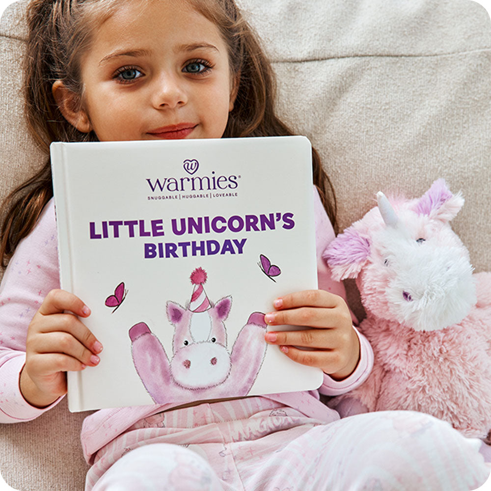 Image 89: toddler holding Little Unicorn's Birthday book with unicorn stuffed animal