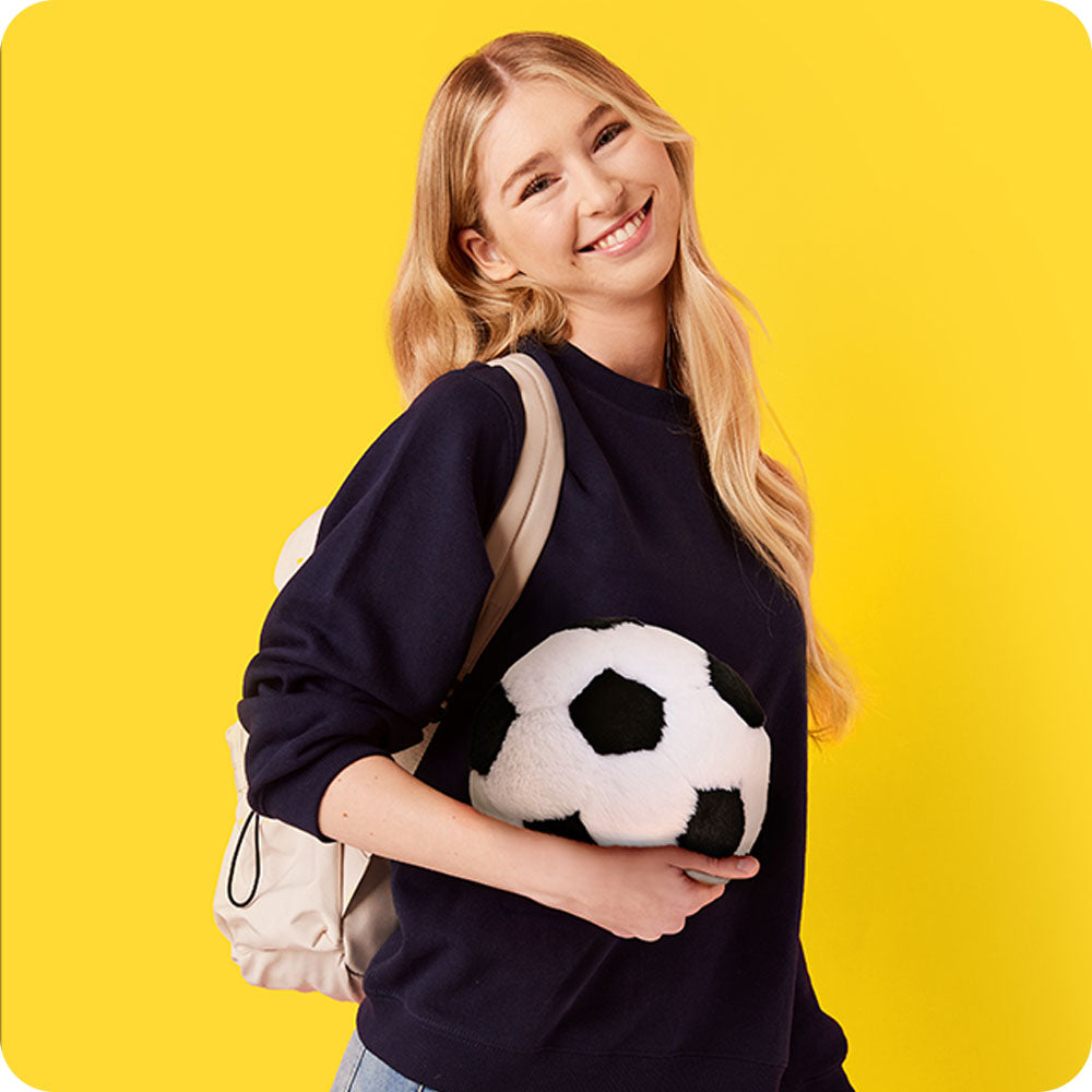 Image 92: girl holding soccer ball stuffed animal warmies