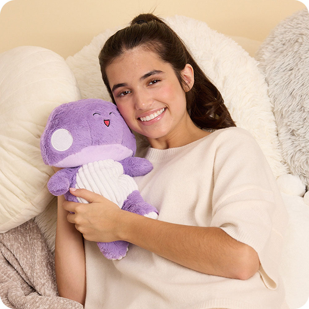 Image 108: girl hugging purple mushroom stuffed animal warmies