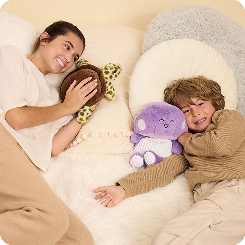 Image 111: girl with turtle stuffed animal and boy with purple mushroom stuffed animal