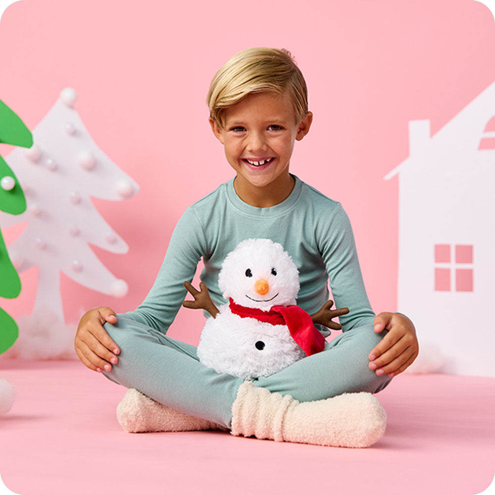 Image 101: boy with warmies snowman stuffed animal